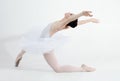 Creative, dance and ballet with a woman in studio on a white background for rehearsal or recital for theatre performance