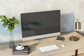 Creative designer desktop with empty computer monitor, lamp, supplies and other items. Concrete wall background. Mock up, 3D Royalty Free Stock Photo