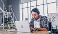 Creative designer feel sleepy while working hard with laptop at modern office.workplace lifesyle concept Royalty Free Stock Photo