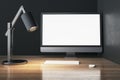 Creative designer wooden desktop with empty white mock up computer monitor, lamp and keyboard. Royalty Free Stock Photo