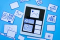 Creative designers designing wireframe sketch layout design mockup on smartphone or tablet screen.