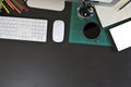 Creative desk workspace with mockup tablet computer and office equipment on black table, top view Royalty Free Stock Photo