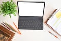Creative desk workspace with mockup tablet computer and office equipment on black table, top view Royalty Free Stock Photo