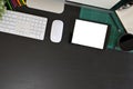 Creative desk workspace with mockup tablet computer and office equipment on black table, top view Royalty Free Stock Photo