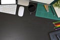 Creative desk workspace with mockup tablet computer and office equipment on black table, top view Royalty Free Stock Photo