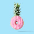 Creative disposition of donut pineapple on bright background.