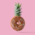 Creative disposition of donut pineapple on bright background. Royalty Free Stock Photo