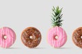 Creative disposition of donut pineapple on bright background. Royalty Free Stock Photo