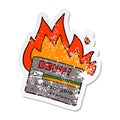 A creative distressed sticker of a burning credit card cartoon