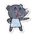 A creative distressed sticker of a cartoon bear in dress laughing and pointing