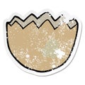 A creative distressed sticker of a cartoon cracked eggshell Royalty Free Stock Photo