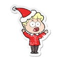 A creative distressed sticker cartoon of a man gasping in surprise wearing santa hat Royalty Free Stock Photo