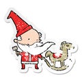 A creative distressed sticker of a cartoon santa making toy