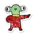 A creative distressed sticker of a friendly cartoon alien pointing