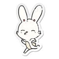 A creative distressed sticker of a running bunny cartoon