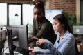 Creative and diverse office people reviewing 3D project progress while solving graphical issues.