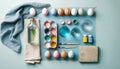 Creative Easter background with eggs, paint, brushes, egg carton and linen cloth. Flat lay on light blue background. Created with Royalty Free Stock Photo