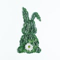 Creative Easter composition with bunny shape made of green natural leaves and flower. Minimal spring holiday background. Flat lay Royalty Free Stock Photo