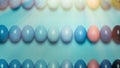 Creative Easter concept. Colored Easter eggs of a blue gradient in a row on a blue background. View from above