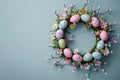 Creative Easter layout made of colorful painted eggs and flowers on pastel blue background Royalty Free Stock Photo