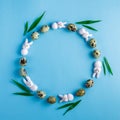 Creative Easter wreath made from motley quail eggs, pink marshmallow bunny