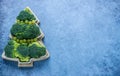 Creative edible Christmas tree made of fresh broccoli.Holiday ideas. New year food background top view . holiday, celebration,