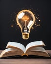 Creative education background with glowing light bulb above open book on black Royalty Free Stock Photo
