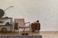 Creative elegant composition of masculine living room interior design with copy space, brown armchair, designed commode. Royalty Free Stock Photo