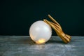 esoteric still life with a ball of predictions and two wooden female hands on concrete table against black wall Royalty Free Stock Photo