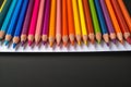 Creative essentials Array of colored pencils and paper on black