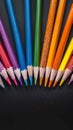 Creative essentials Array of colored pencils and paper on black