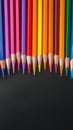 Creative essentials Array of colored pencils and paper on black