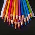 Creative essentials Array of colored pencils and paper on black