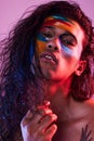 Creative, face paint and art with portrait of man in studio for beauty, self love and designer. Fantasy, neon and light