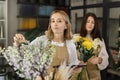 Creative female designer sit at desk in modern shop interior and make order for next period Royalty Free Stock Photo