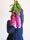 Creative female faceless portrait with bunch of flowers