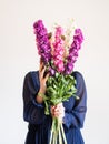 Creative female faceless portrait with bunch of flowers
