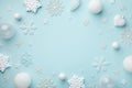 Creative festive frame with white holiday balls and decorative snowflakes on turquoise pastel background. Christmas card. Flat lay Royalty Free Stock Photo