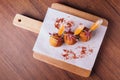 Creative fine dining: Chicken Biryani Srancini served in rice ball with sweet and spicy dip on wooden chop board Royalty Free Stock Photo