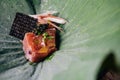 Creative Fine Dinning: Close up Tuna with yuzu-miso topping with black caviar and avocado served in lotus leaf