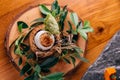Creative Fine Dinning: Soft-boiled eggs with shell decorated with small branches, leaves and straw Royalty Free Stock Photo