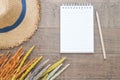 Creative flat lay of Autumn and Fall concept, Dried flowers, straw hat and blank notebook with pencil on wooden