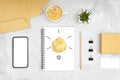Creative flat lay composition. Glowing light bulb made of crumpled paper ball on the office desk. Royalty Free Stock Photo
