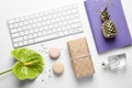 Creative flat lay composition with tropical flower, gift box and computer keyboard Royalty Free Stock Photo