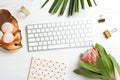 Creative flat lay composition with tropical flower, macaroons and computer keyboard Royalty Free Stock Photo