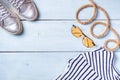 Creative flat lay concept of summer travel vacations. Top view of shiny sneakers, sunglasses and rope on pastel blue background wi