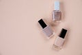Creative flat lay of fashion bright nail polishes on a beige background. Minimal style. Copy space. Beauty blogger Royalty Free Stock Photo