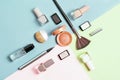 Creative flat lay of fashion bright nail polishes and decorative cosmetic on a colorful background. Minimal style. Copy