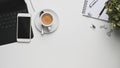 Creative flat lay office desk. Laptop, notebooks and coffee cup with smartphone on office desk. Royalty Free Stock Photo