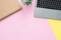 Creative flat lay photo of workspace desk. Top view office desk with laptop and blank empty notebooks on pastel pink yellow colou. Royalty Free Stock Photo